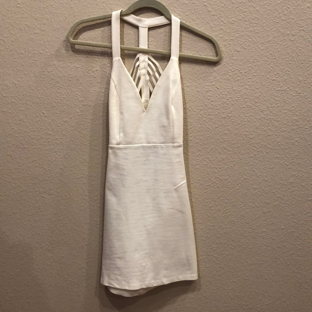 Cream colored dress, sleeveless.